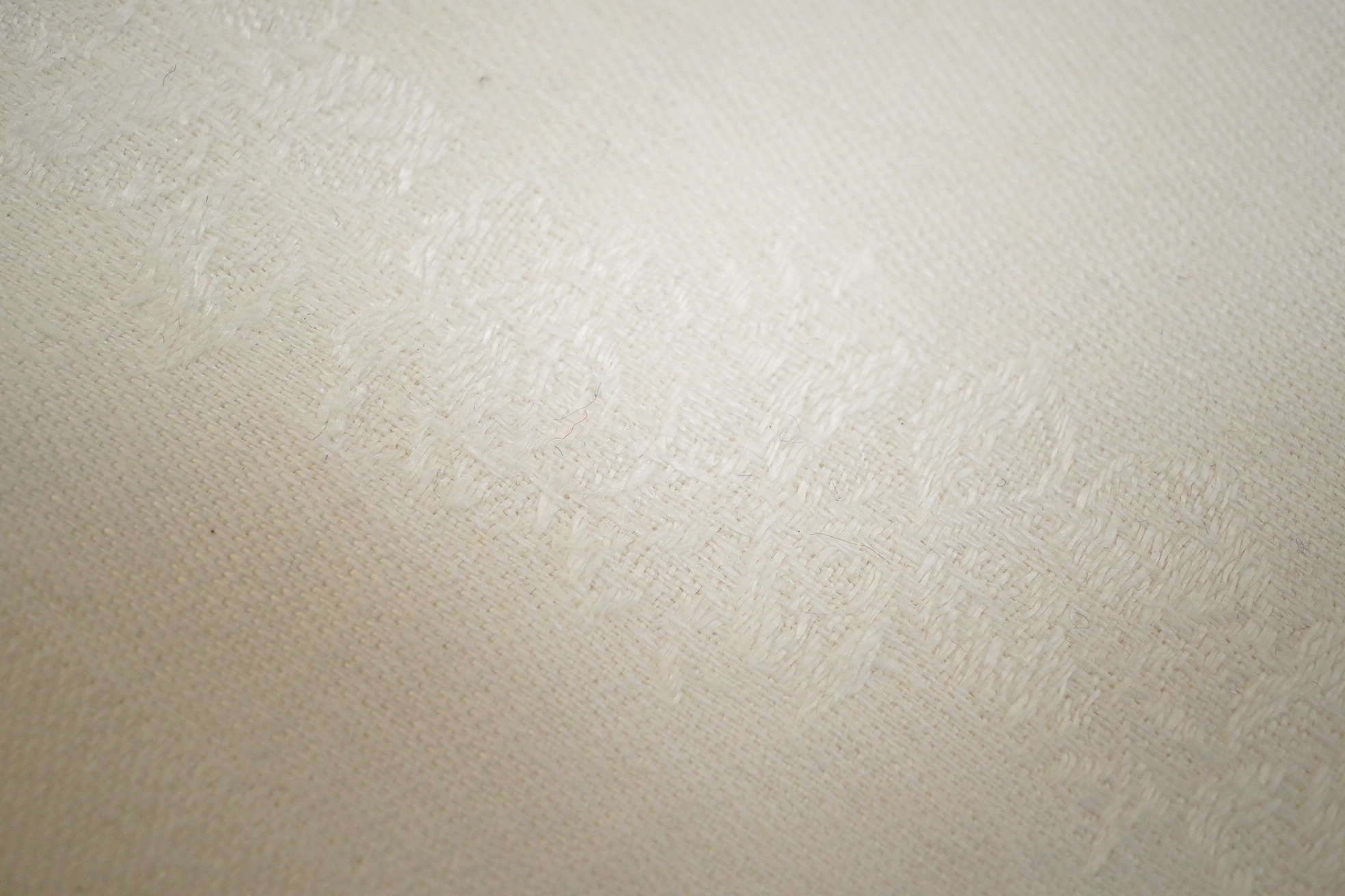 Twelve large damask dinner napkins, eleven smaller damask napkins, together with a cream monogrammed table cloth and twelve matching dinner napkins, cream monogrammed damask table cloth 230cm long x 152cm wide, matching